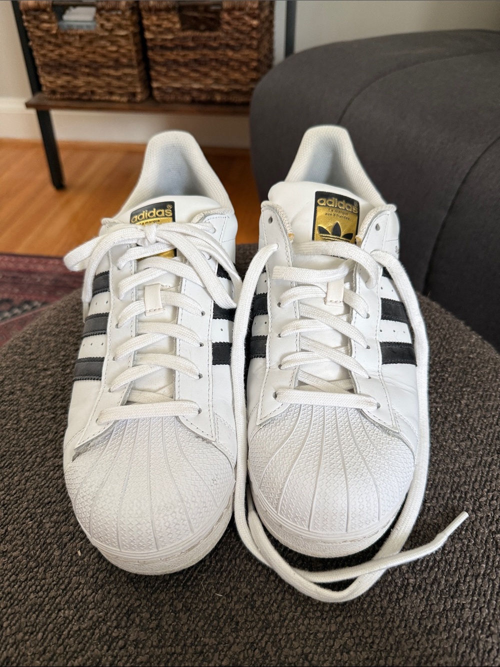 Adidas Superstar Sneakers with Black Stripes and Gold Accents